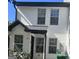 Charming two-story townhouse with white siding and black trim around the windows and entryway at 2353 Wellington Cir, Lithonia, GA 30058