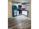 Well-lit kitchen featuring stainless steel appliances, white cabinets and modern laminate flooring at 2353 Wellington Cir, Lithonia, GA 30058