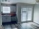 Kitchen featuring sleek countertops, modern appliances, and a sliding glass door to the outside at 2353 Wellington Cir, Lithonia, GA 30058