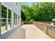 Light blue home exterior with white trim and a light colored wood deck overlooks a backyard pool at 1928 Main Nw St, Atlanta, GA 30318