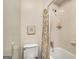 Bright bathroom featuring tiled walls, neutral shower curtain, and shower-tub combination at 1928 Main Nw St, Atlanta, GA 30318