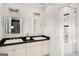 This bathroom features a double sink vanity, a shower, and white and black tile on the floor at 1928 Main Nw St, Atlanta, GA 30318