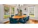 Elegant dining room featuring natural light, a modern chandelier, wood flooring, and neutral wall paint at 1928 Main Nw St, Atlanta, GA 30318