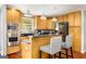 Modern kitchen with stainless steel appliances, wooden cabinets, granite countertops, and a breakfast bar area at 1928 Main Nw St, Atlanta, GA 30318