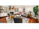 Cozy living room featuring a gray sofa, fireplace, stylish decor, and a large patterned rug on hardwood floors at 1928 Main Nw St, Atlanta, GA 30318