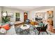 Bright living room showcasing modern decor, a gray sofa, natural light, and an open layout with hardwood floors at 1928 Main Nw St, Atlanta, GA 30318