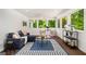 Inviting sun room featuring ample seating and large windows offering scenic views of the outdoors at 1928 Main Nw St, Atlanta, GA 30318