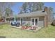 The back of the house features a patio with lounge chairs and outdoor seating at 200 Doe Run, Peachtree City, GA 30269