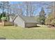 View of the backyard, featuring a well-maintained lawn and the house exterior with matching siding at 200 Doe Run, Peachtree City, GA 30269