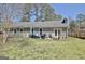 Spacious backyard with patio, seating, and beautiful landscaping at 200 Doe Run, Peachtree City, GA 30269