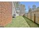 Fenced-in backyard features a grill and well-kept lawn, ideal for outdoor activities at 200 Doe Run, Peachtree City, GA 30269