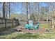 This property includes a backyard seating area with Adirondack chairs and a storage shed at 200 Doe Run, Peachtree City, GA 30269