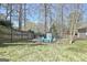 Backyard with fencing, shed and a seating area with Adirondack chairs at 200 Doe Run, Peachtree City, GA 30269