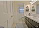 Bathroom featuring neutral colors, a wide vanity, an open doorway, and decorative accents at 200 Doe Run, Peachtree City, GA 30269