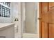 Bathroom featuring shower, toilet and black and white patterned curtains at 200 Doe Run, Peachtree City, GA 30269