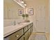 Bathroom with an elongated vanity, light tile floors, and a patterned blue and white rug at 200 Doe Run, Peachtree City, GA 30269