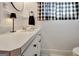 Bathroom vanity with white cabinets, dark hardware, and modern light fixture with black and white curtains at 200 Doe Run, Peachtree City, GA 30269