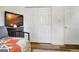 Bedroom with hardwood floors, flat screen TV, and a double door closet with white doors at 200 Doe Run, Peachtree City, GA 30269