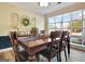 Dining room features large window and chairs around a wooden dining table at 200 Doe Run, Peachtree City, GA 30269