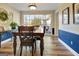 View of dining room table and chairs with a large picture window at 200 Doe Run, Peachtree City, GA 30269