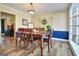 Dining room featuring decorative wall art, a wooden table, and a large picture window at 200 Doe Run, Peachtree City, GA 30269
