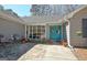 Welcoming front entrance featuring a vibrant blue door, decorative plants, and an outdoor seating area at 200 Doe Run, Peachtree City, GA 30269