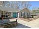 Welcoming front entrance featuring a vibrant blue door, decorative plants, and an outdoor seating area at 200 Doe Run, Peachtree City, GA 30269