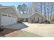 Charming home exterior with a wide driveway, a vibrant blue front door, and attached two-car garage at 200 Doe Run, Peachtree City, GA 30269