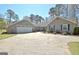 Charming home exterior with a wide driveway, a vibrant blue front door, and attached two-car garage at 200 Doe Run, Peachtree City, GA 30269