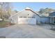 Attached garage with a double door, next to a seating area, and beautifully landscaped surroundings at 200 Doe Run, Peachtree City, GA 30269