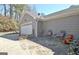 Attached garage with a double door, next to a seating area, and beautifully landscaped surroundings at 200 Doe Run, Peachtree City, GA 30269