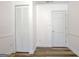 Hallway features fresh white walls and trim and wood-look flooring at 200 Doe Run, Peachtree City, GA 30269