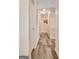 Hallway with wood flooring, beige walls, and white doors leading to various rooms at 200 Doe Run, Peachtree City, GA 30269