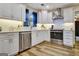 Modern kitchen with stainless steel appliances, white cabinets, tile backsplash, and natural light at 200 Doe Run, Peachtree City, GA 30269
