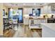 Bright kitchen features white cabinets, backsplash, island, and a dining table at 200 Doe Run, Peachtree City, GA 30269