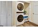 Functional laundry area with stacked washer and dryer and storage, offering practical space-saving solutions at 200 Doe Run, Peachtree City, GA 30269