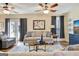 Bright living room featuring wood floors, a comfortable sofa, and a view of the backyard at 200 Doe Run, Peachtree City, GA 30269