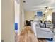 Comfortable living room with wood floors, a cozy sofa, a fireplace, and an adjacent dining area at 200 Doe Run, Peachtree City, GA 30269