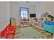Spacious playroom is filled with toys, cheerful decor, and plenty of space to play at 200 Doe Run, Peachtree City, GA 30269