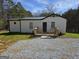 Charming single-story home with a metal roof, light siding, and a welcoming wooden front porch at 4064 Post Rd, Winston, GA 30187