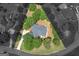 Expansive aerial view of the property showcasing lush greenery, manicured lawns, and the home's unique triangular lot at 1103 Wilder Ct, Mcdonough, GA 30252