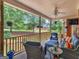 Inviting back porch featuring comfortable wicker seating, ceiling fan, and serene backyard views at 1103 Wilder Ct, Mcdonough, GA 30252