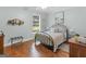 Cozy bedroom features hardwood floors, a ceiling fan, a large window, and light blue walls at 1103 Wilder Ct, Mcdonough, GA 30252