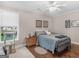 Bedroom features hardwood floors, a ceiling fan, a large window, neutral paint, and a double bed at 1103 Wilder Ct, Mcdonough, GA 30252