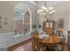 Elegant dining room featuring a wooden table, ample natural light, and stylish chandelier perfect for gatherings at 1103 Wilder Ct, Mcdonough, GA 30252
