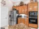 Kitchen features granite countertops, wood cabinetry, stainless steel refrigerator, and built in microwave and oven at 1103 Wilder Ct, Mcdonough, GA 30252