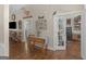 Inviting living room featuring hardwood floors, a console table, and an open doorway to an adjacent room at 1103 Wilder Ct, Mcdonough, GA 30252