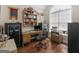 Well-lit office space with hardwood floors, a large window, and built-in shelving for optimal organization at 1103 Wilder Ct, Mcdonough, GA 30252