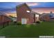 Brick home featuring a spacious backyard with lush green grass, privacy fence and a covered patio at 375 Oakpark Ter, Mcdonough, GA 30253