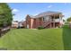 Brick home showcasing a large, well-maintained backyard and a screened porch at 375 Oakpark Ter, Mcdonough, GA 30253